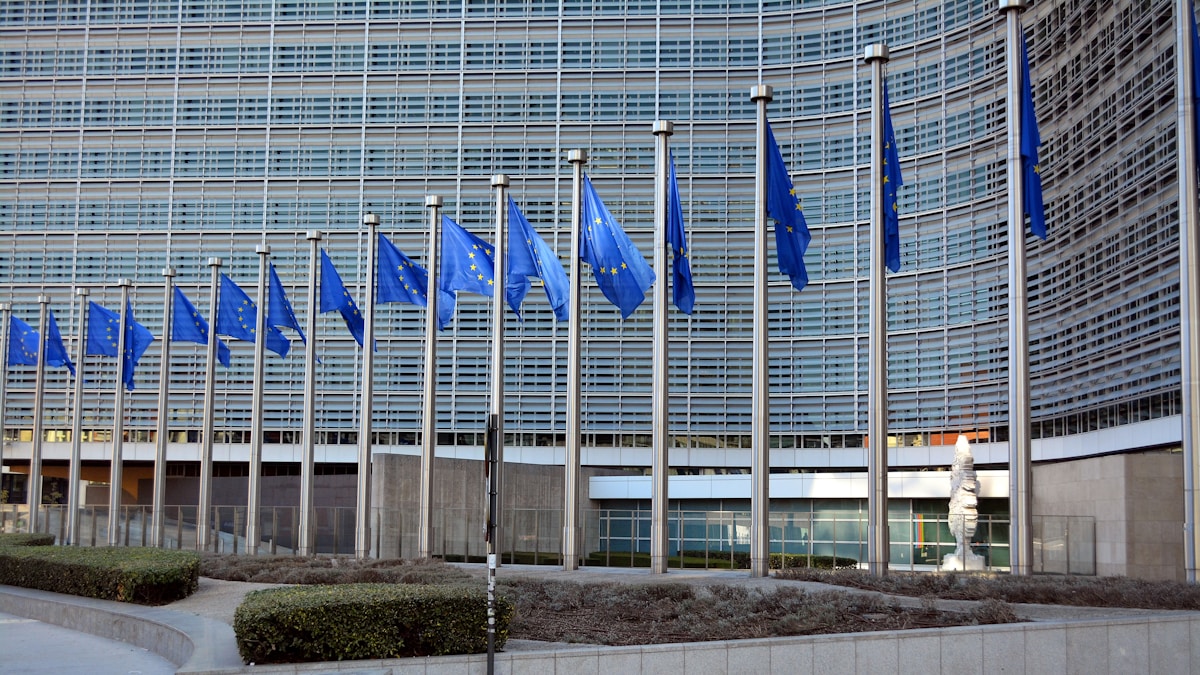 European Union flags in front of the Berlaymont building in Brussels.
