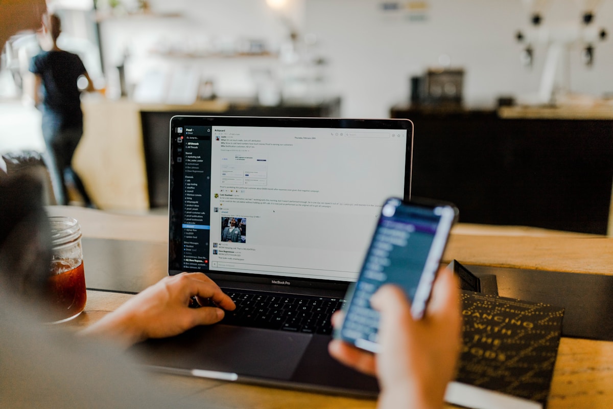 Person using a smartphone at a desk.