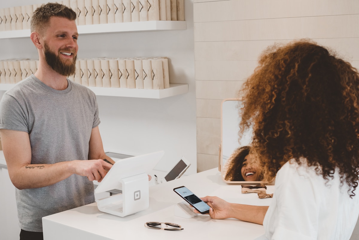 Hands holding a smartphone during a mobile payment.